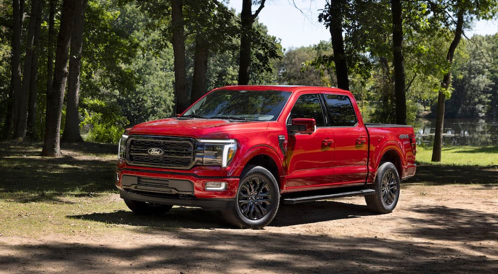 A red 2025 Ford F-150 Lariat from the front after leaving a Ford dealer.