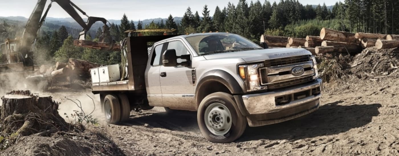 White 2018 Ford F-450 with the flat bed on a job site