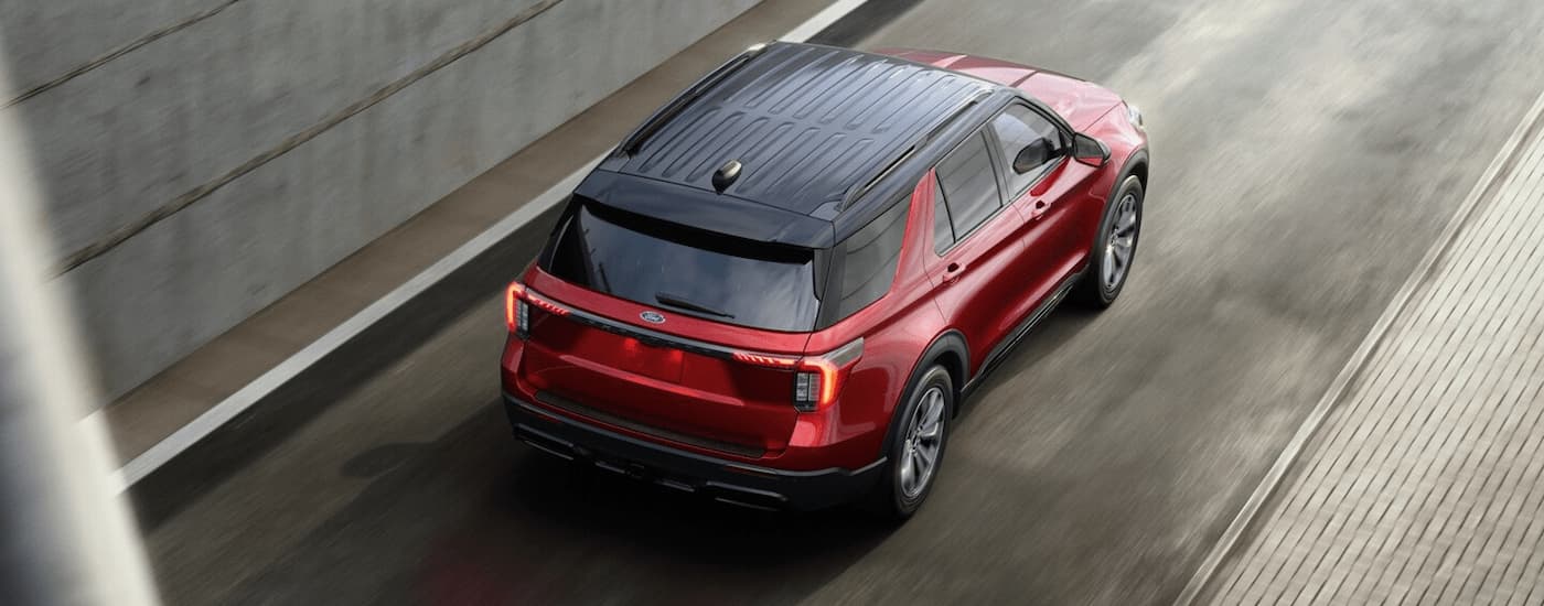 Red 2025 Ford Explorer driving on a highway ramp