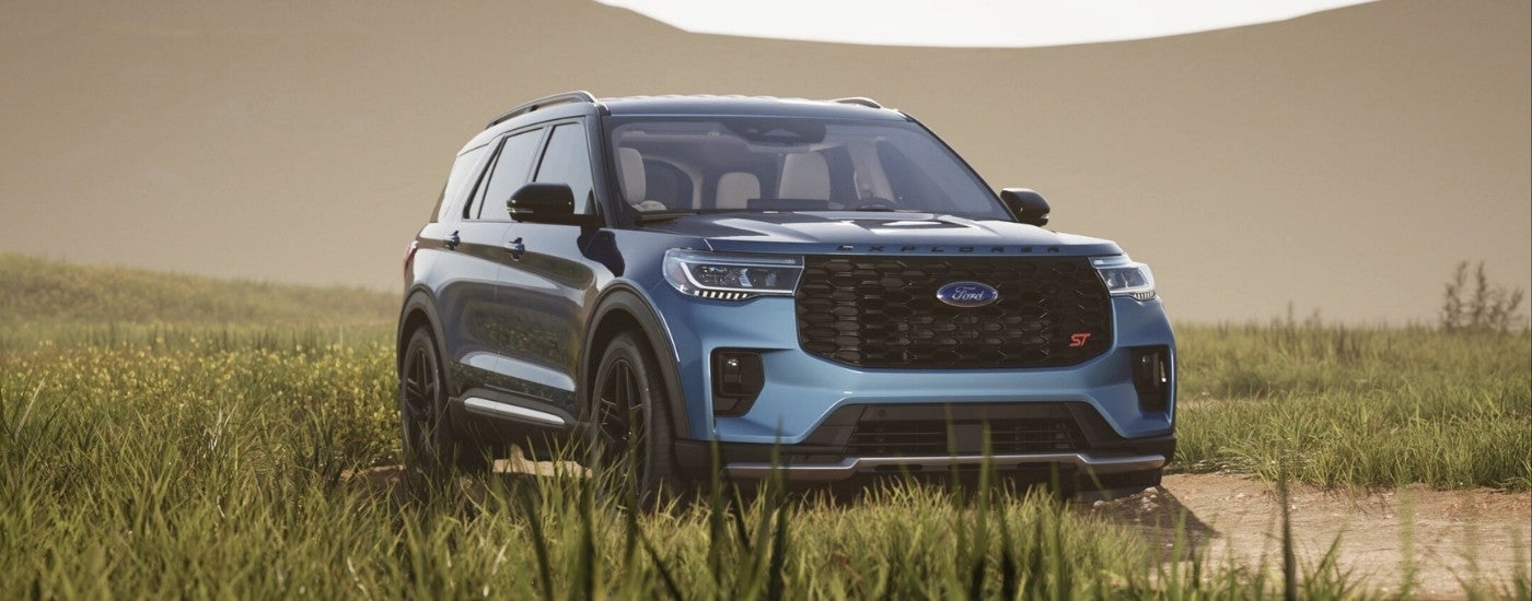Blue 2026 Ford Explorer ST parked in long grass