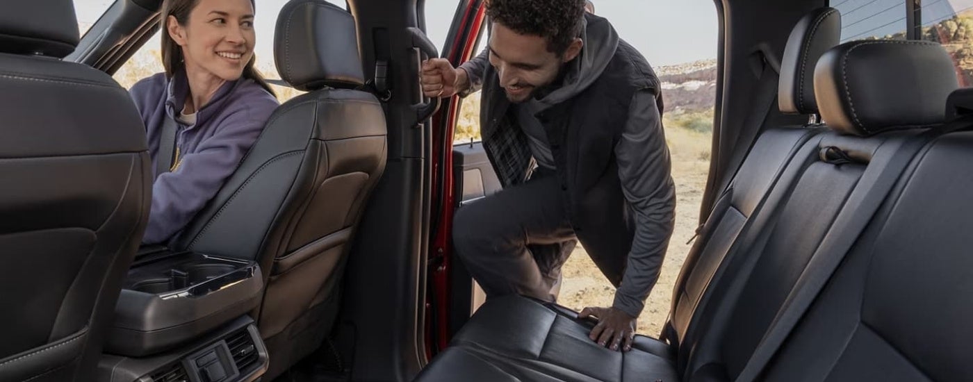 Person getting into the back of a 2025 Ford F-150