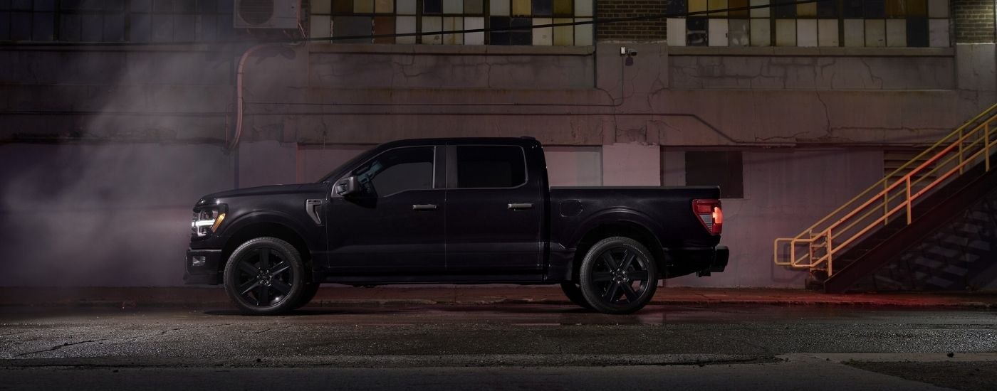 Black 2025 Ford F-150 Lobo parked near a warehouse