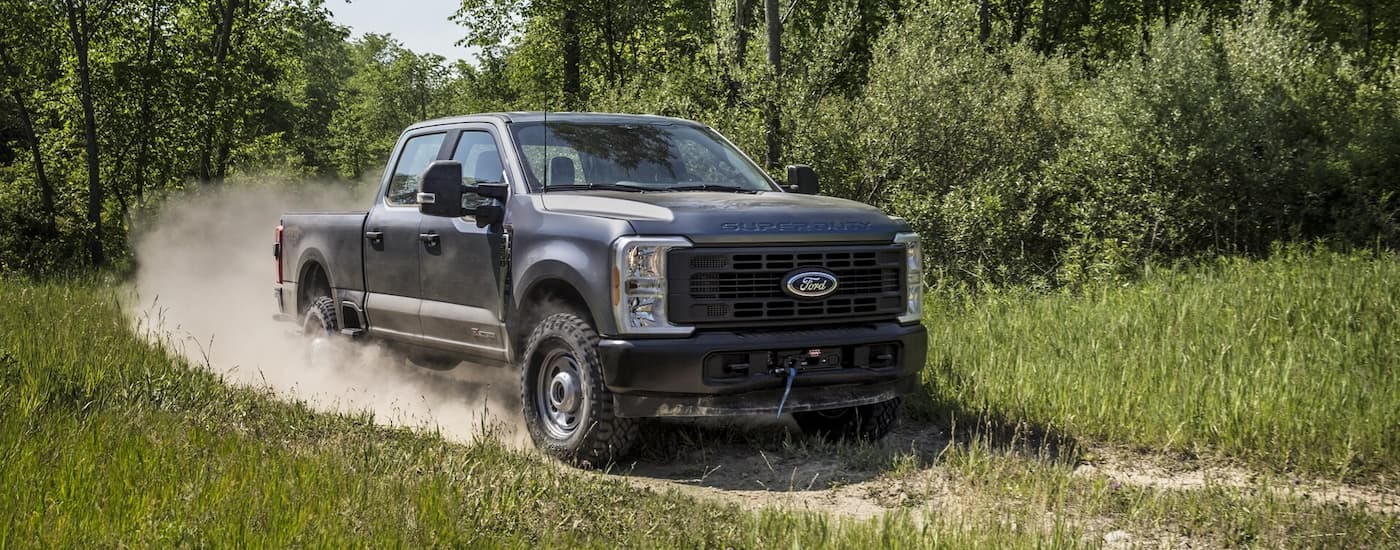 Grey 2026 Ford F-250 driving off-road.