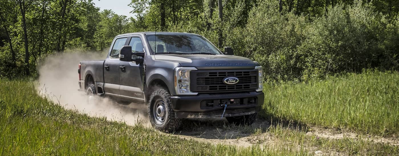 Grey 2026 Ford F-250 driving off-road.