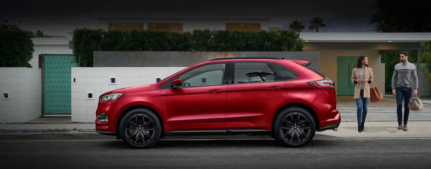 A red 2024 Ford Edge parked near a curb.