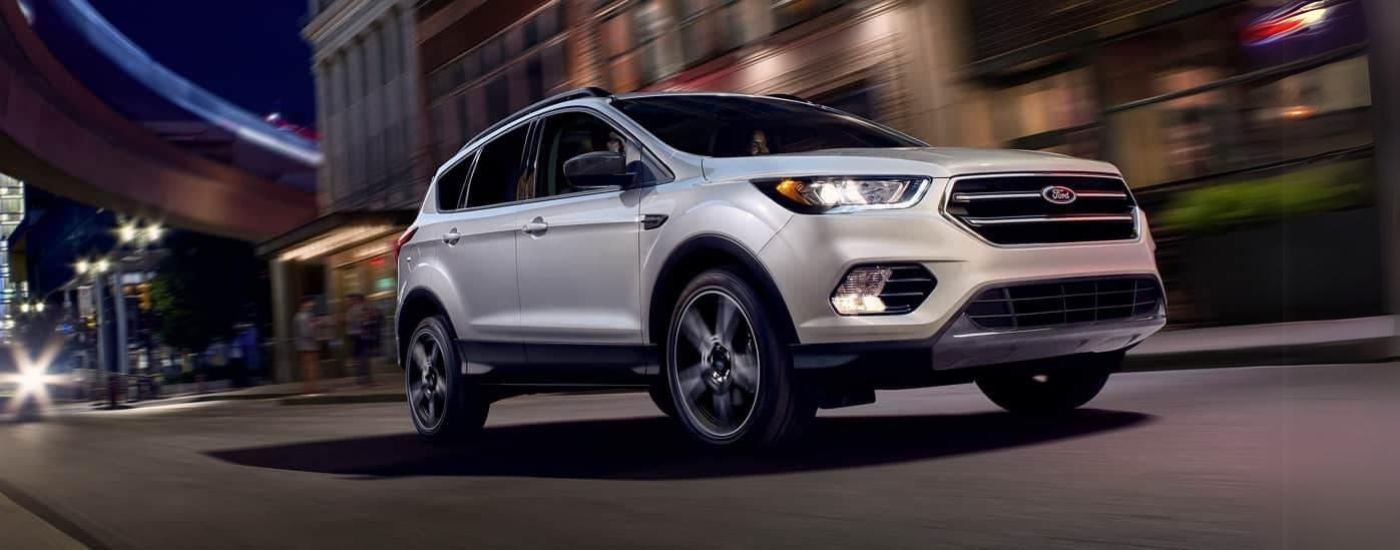 White used 2019 Ford Escape for sale near Rockford driving down a city street.