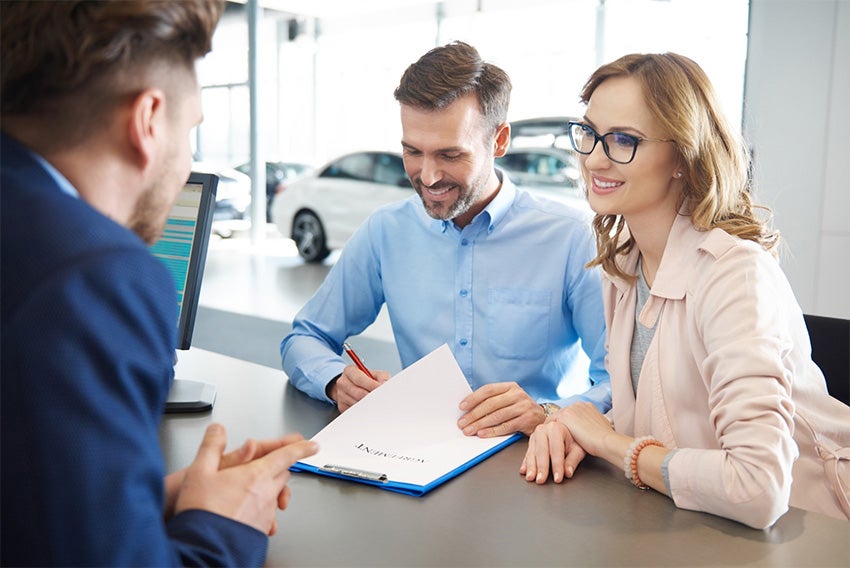 Dealership Signing Paper Couple | LaFontaine Ford Grand Rapids in Grand Rapids MI